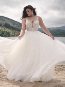 Stunning plus size bride wearing wedding dress from Aurora Bridal Boutique.