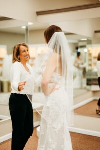 Cami Hester, owner of Aurora Bridal Boutique working with a Bride to Be.