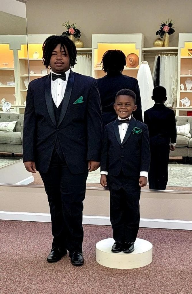 groom and child in matching tuxedos