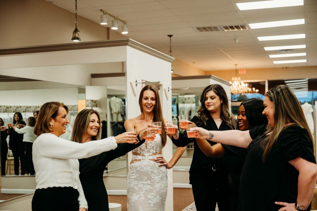 Bride and her bridesmaids in Aurora Bridal all celebrating finding their dresses.