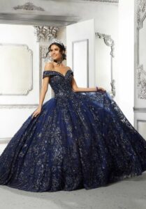 Rich, navy blue quinceañera ball gown with silver beaded accents from Aurora Bridal Boutique.