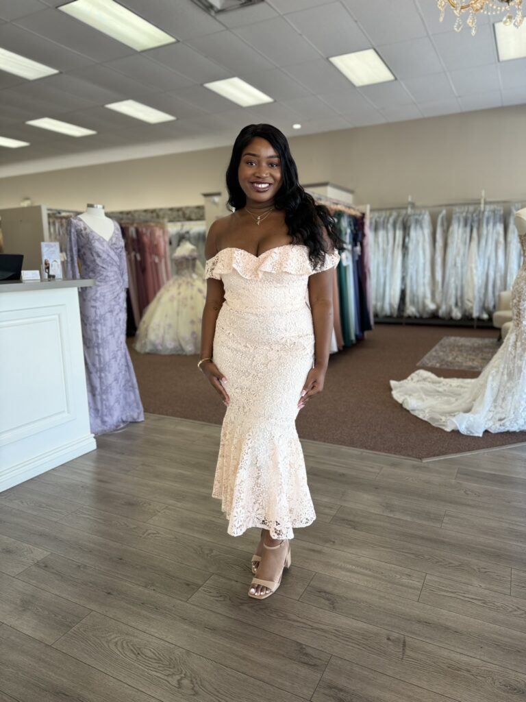 Woman in a colorful bridesmaid dress standing in a Florida wedding shop