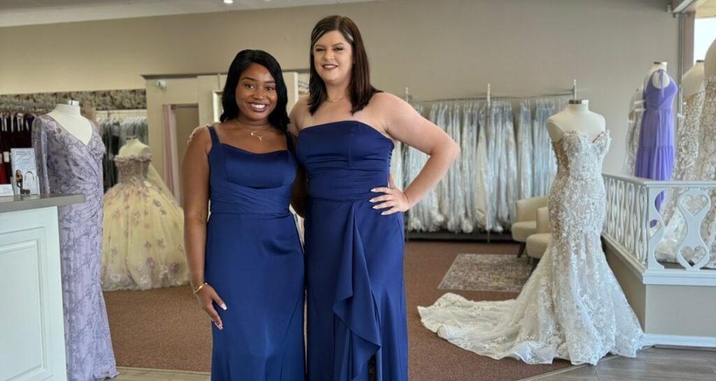 Women showcasing blue bridesmaid dresses at a Florida wedding store