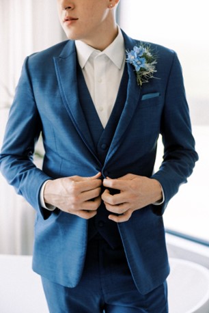 groom in a blue formal wear suit that would work well for a prom suit or a groomsmen suit