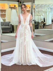 beautiful woman wearing a white wedding dress with lace details at Aurora Bridal in Florida