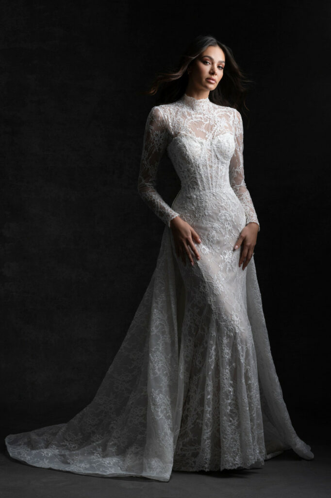 A bride wearing a sheath wedding dress with long lace sleeves