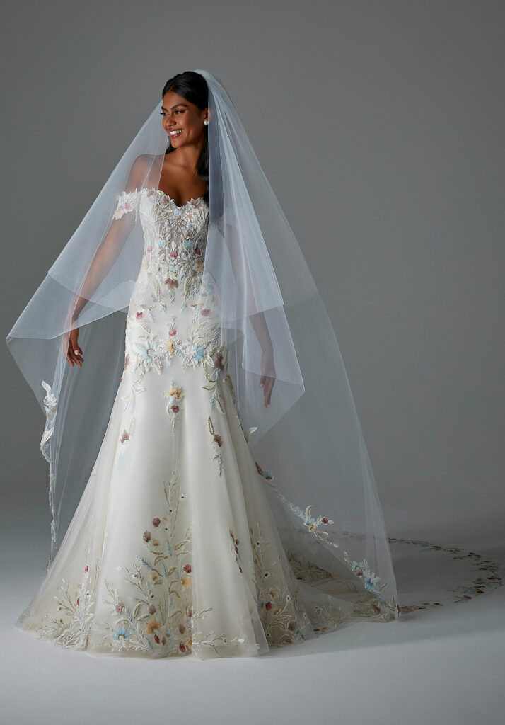 Bride wearing a sophisticated floral wedding dress with a sheer veil.