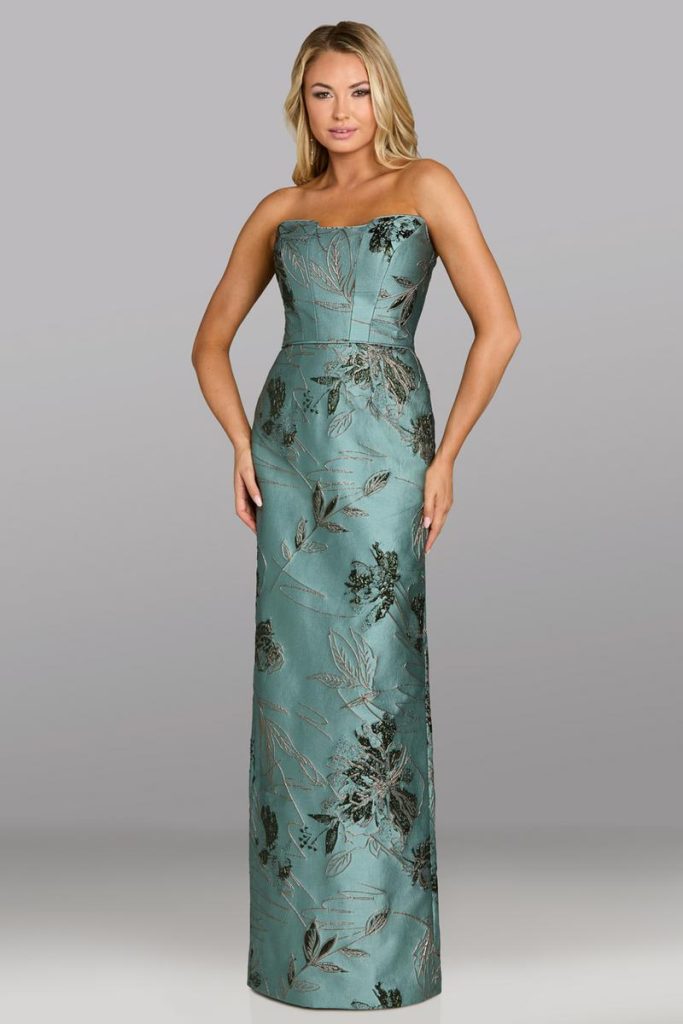 A woman models a strapless teal floral jacquard column gown against a light gray studio background.